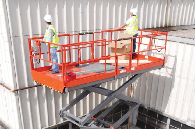 Two workers using access equipment